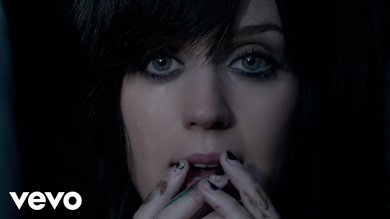 Katy Perry 'The One That Got Away' MV capture: Katy Perry in close-up with black bangs and tears in her eyes, fingers with smudged black nail polish at her lips