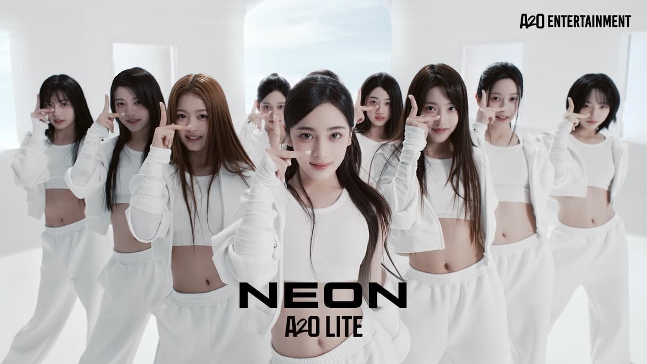 A2O LITE's nine members in white, each holding a hand sign beside one eye in a white room, on the thumbnail of the 'NEON' music video