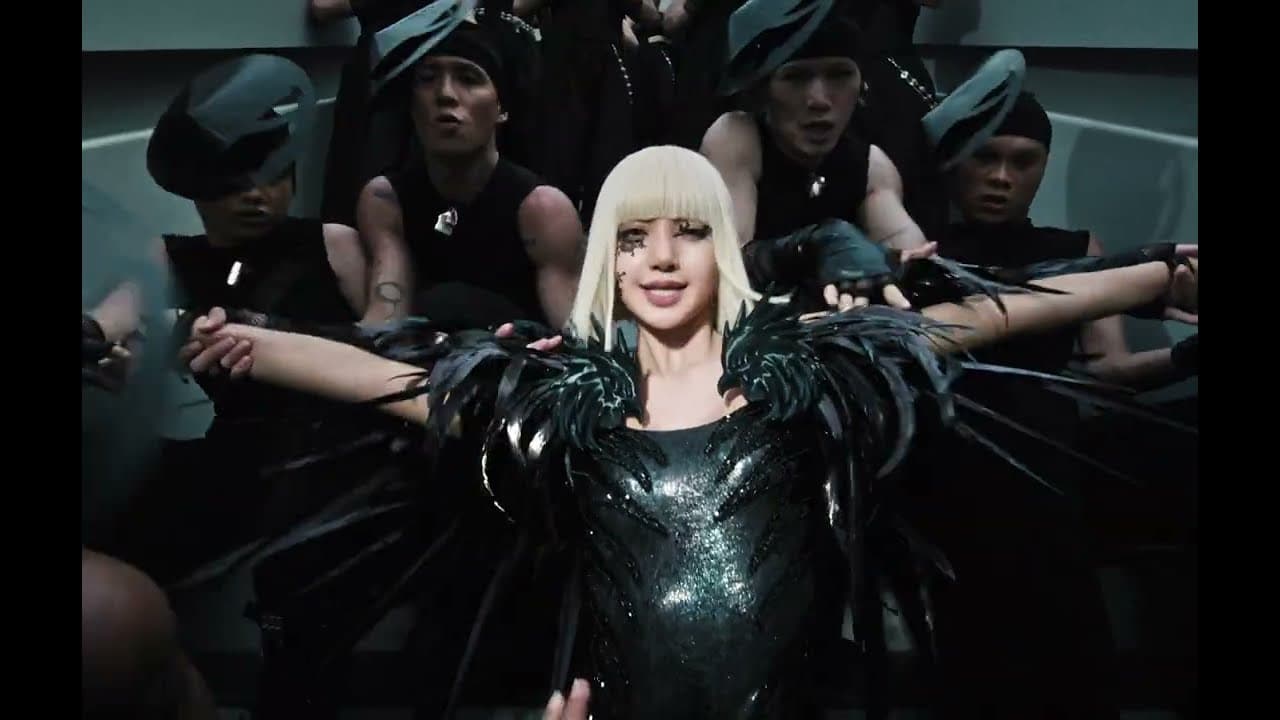 LISA in a platinum bob and a black feathered catsuit spreads her arms in front of her dancers in the 'SaWaDiKa' music video