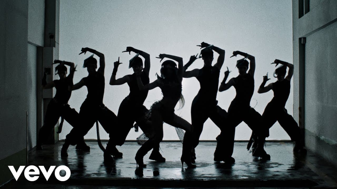 LISA and seven dancers in silhouette against a bright wall, mid-choreography, in the 'SaWaDiKa' music video