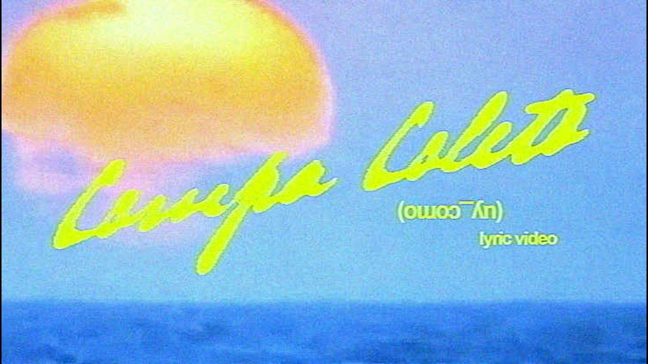 Aria Vega's 'COMPA COLETO (uy_como)' lyric video title card: the song's name in yellow script over a hazy Caribbean sunset