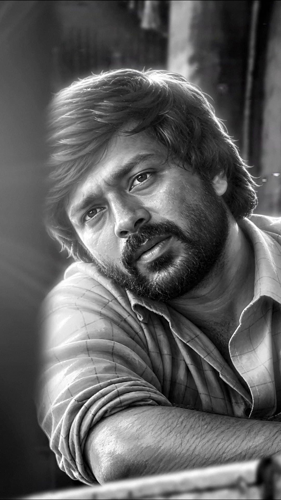 A painted black-and-white portrait of one of the two friends in 'Dorothy', bearded, in a checked shirt, leaning on a rail, from the lyric video for 'Kanagamani'