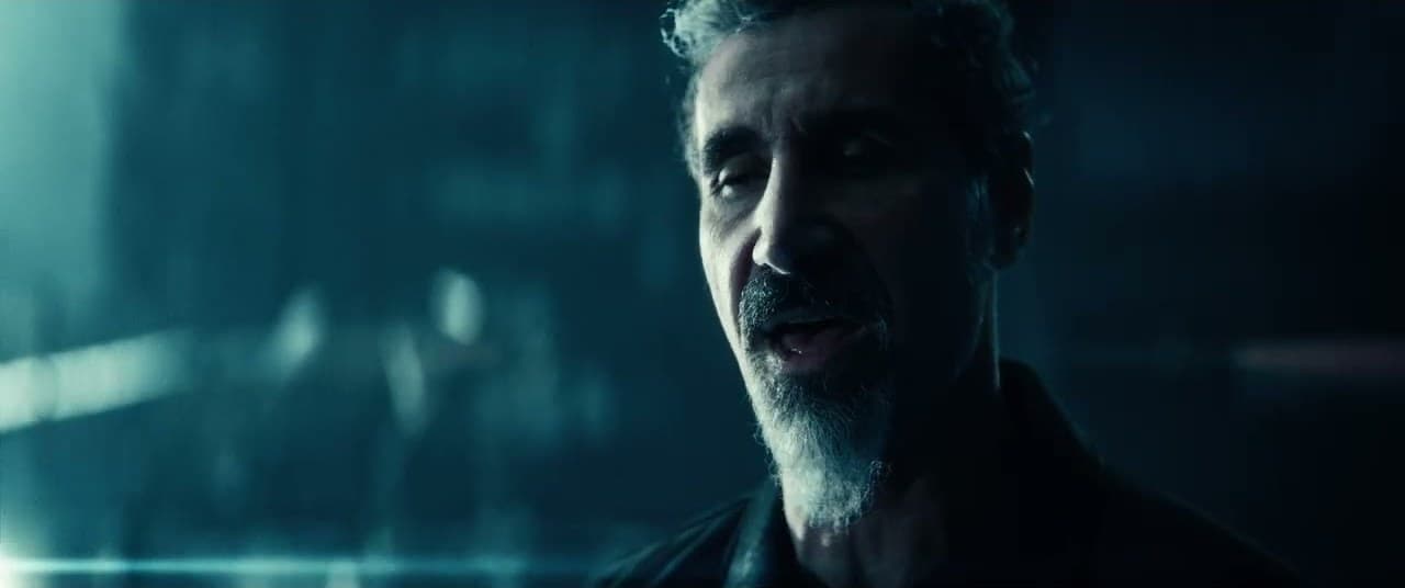 Falling In Reverse 'Joseph' MV capture: a gray-bearded man sings quietly in dim teal light